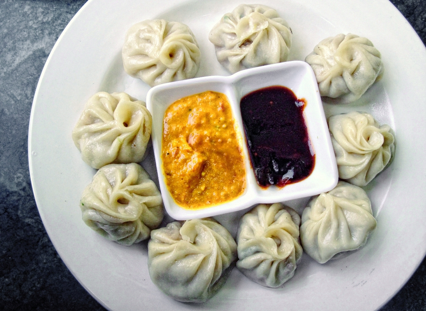 Steamed Nepali chicken momos with tomato chile chutney